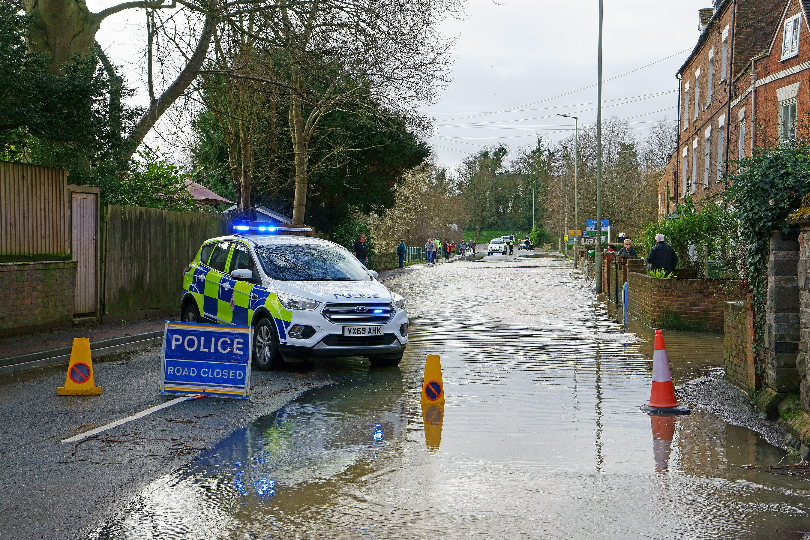 A flooded street that has been sectioned off by police