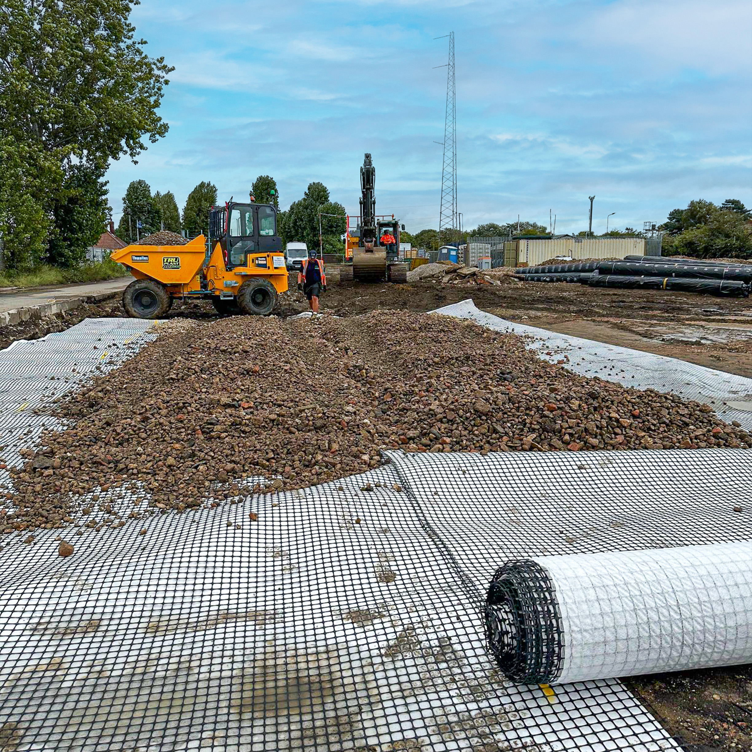 A geocomposite being rolled out for a construction project