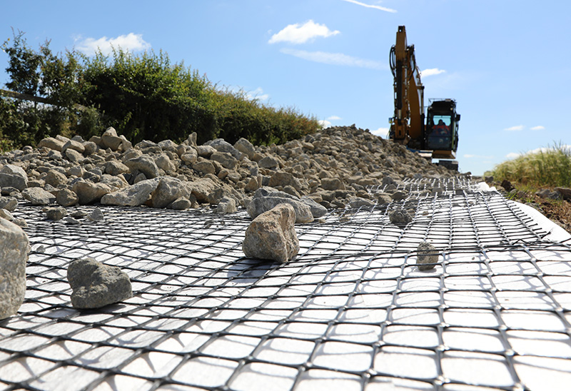 A geotextile and geogrid in use on a haul road to reduce aggregate