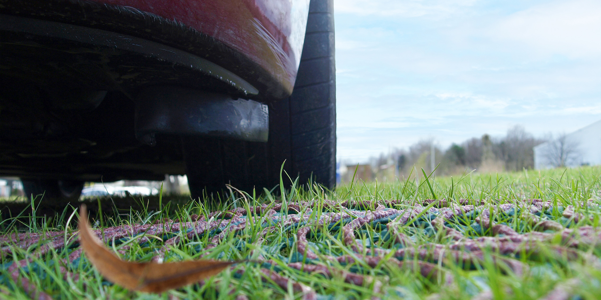 TurfMesh in use under a car to protect a field