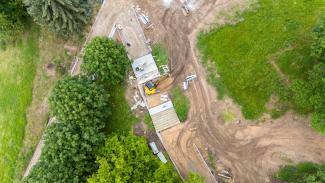 Arial view of construction and machinery taking place near trees