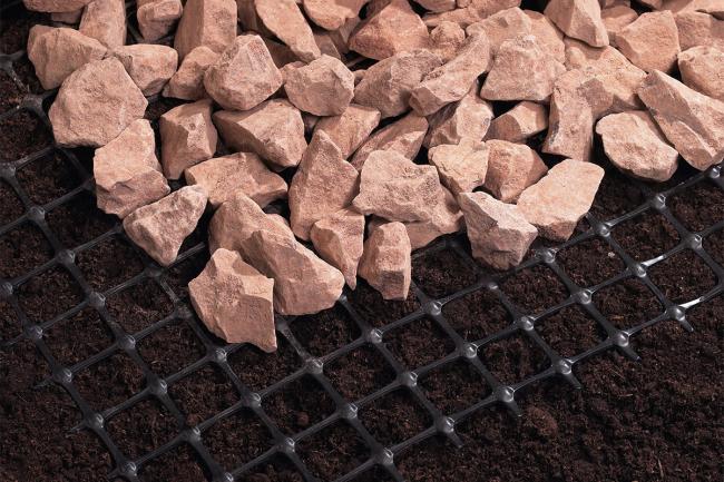 Geogrid over soil, with stones